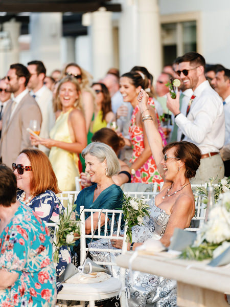 Guests applauding during outdoor ceremony at luxury Cyprus resort.