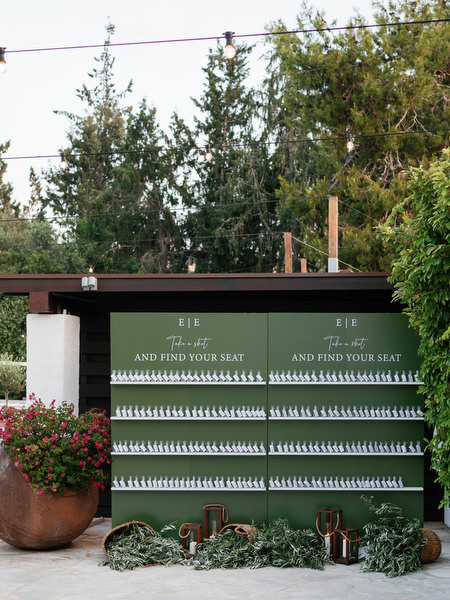 Green escort card wall display at Anassa Hotel Cyprus reception.