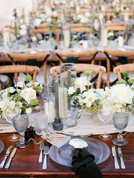 White floral centrepiece on reception table at Anassa Hotel wedding.