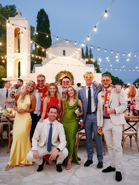 Wedding guests posing at sunset during Anassa Hotel Cyprus reception.