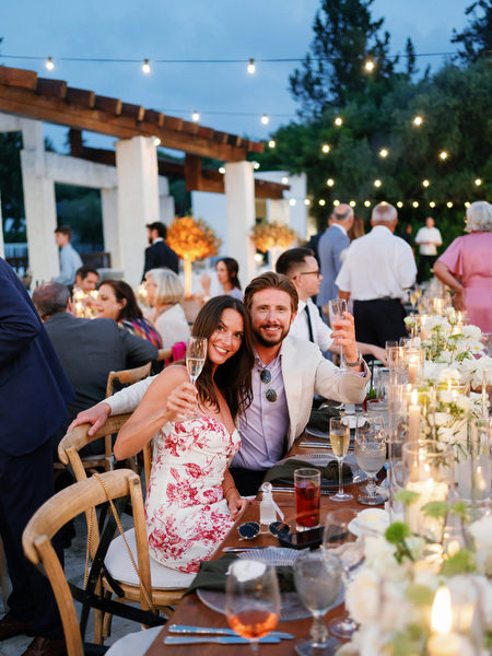 Wedding guests raising glasses at Anassa Hotel Cyprus reception.