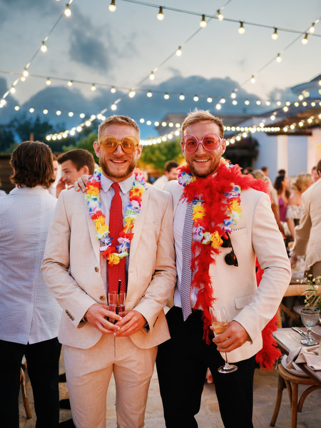 Groomsmen wearing leis during evening reception at Anassa Hotel Cyprus.