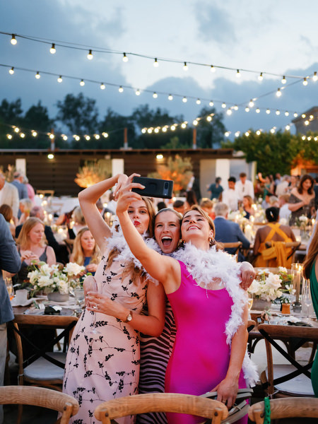 Guests taking selfies at outdoor reception at Anassa Hotel Cyprus.