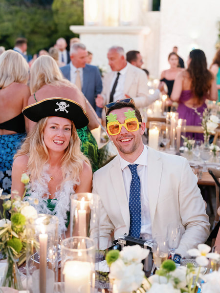 Wedding guests wearing fun party glasses at Anassa Hotel Cyprus reception.