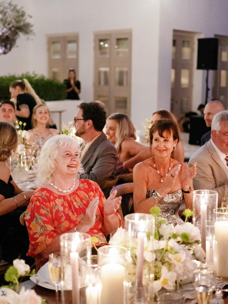 Wedding guests reacting during speech at Anassa Hotel Cyprus reception.