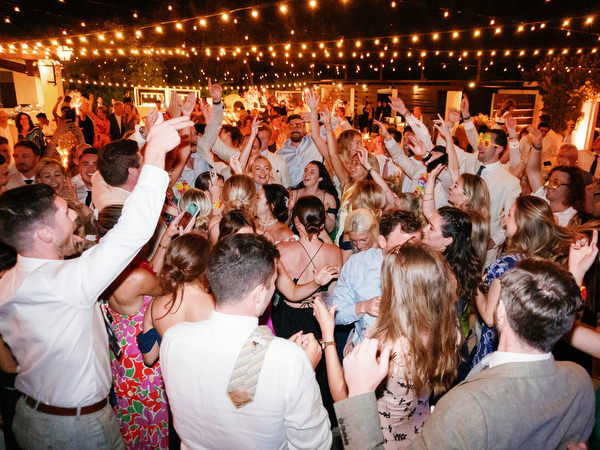 Wedding party dancing under string lights at Anassa Hotel Cyprus.