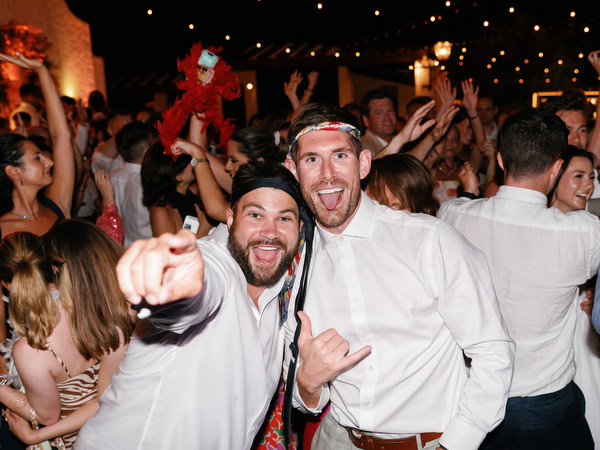 Guests dancing and cheering during Anassa Hotel Cyprus wedding party.