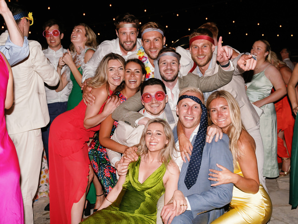 Group of friends posing during Anassa Hotel Cyprus wedding party.