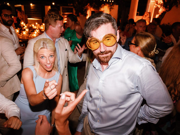 Guest wearing fun glasses at Anassa Hotel Cyprus wedding reception.