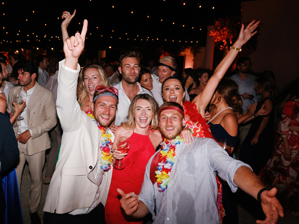 Wedding guests celebrating under festoon lights at Cyprus resort wedding.