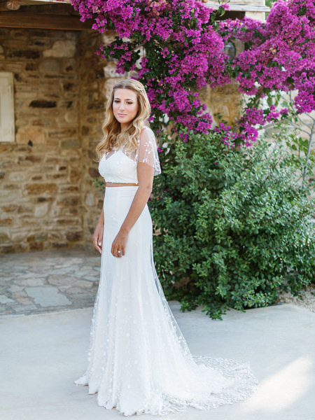 Bride portrait beneath bougainvillea at Antiparos destination wedding.