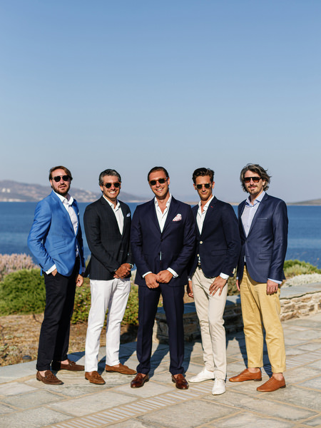 Groomsmen posing by the sea in Antiparos, Greece.