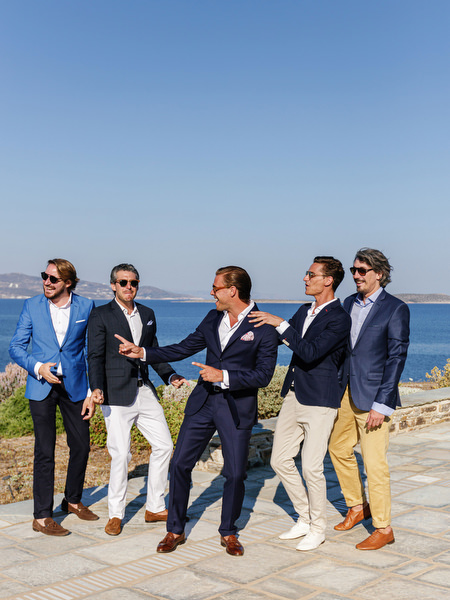 Groom and groomsmen posing by the sea in Antiparos, Greece.