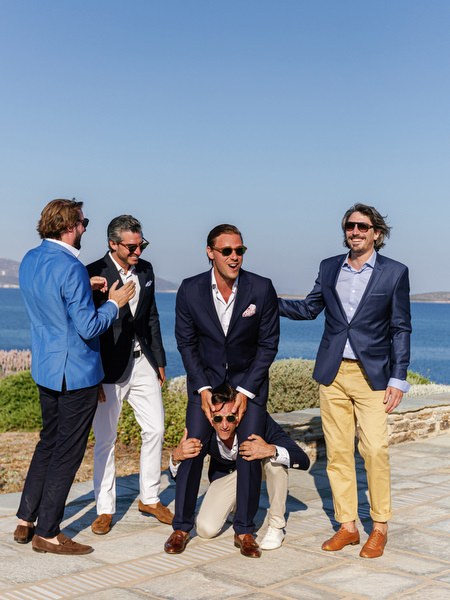 Groomsmen preparing for ceremony at Antiparos cliffside wedding.