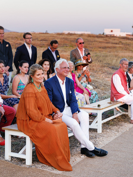 Wedding guests watching ceremony at Antiparos destination wedding.