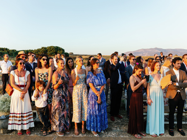 Guest seated at sunset ceremony during Antiparos destination wedding.