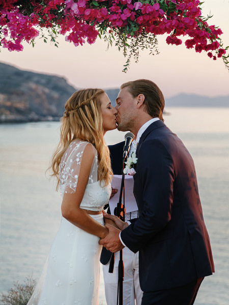 Sunset kiss during Antiparos destination wedding ceremony.