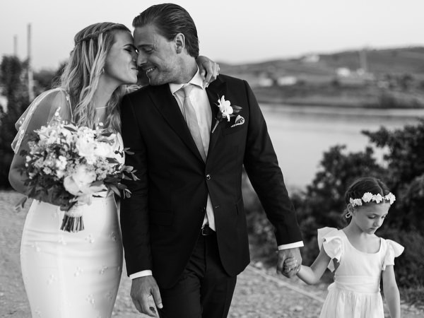 Bride and groom walking with flower girl after Antiparos ceremony.