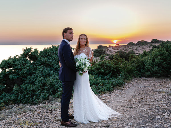 Bride and groom posing at sunset during Antiparos destination wedding.