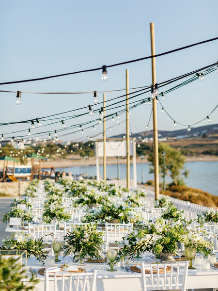 Outdoor seaside wedding reception with string lights in Antiparos.