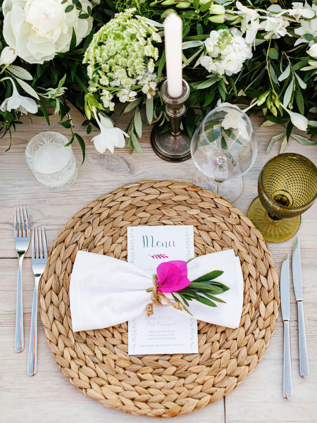 Wedding menu detail with pink flower at Antiparos reception.