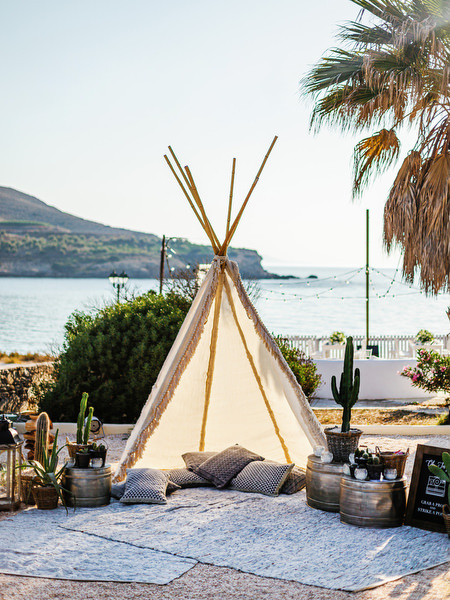 Outdoor wedding lounge decor with lanterns overlooking the sea in Antiparos.