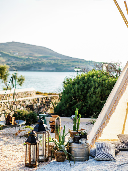 Boho lounge area with teepee at Antiparos seaside wedding.