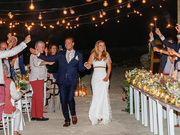 Outdoor wedding reception under string lights in Antiparos at night.