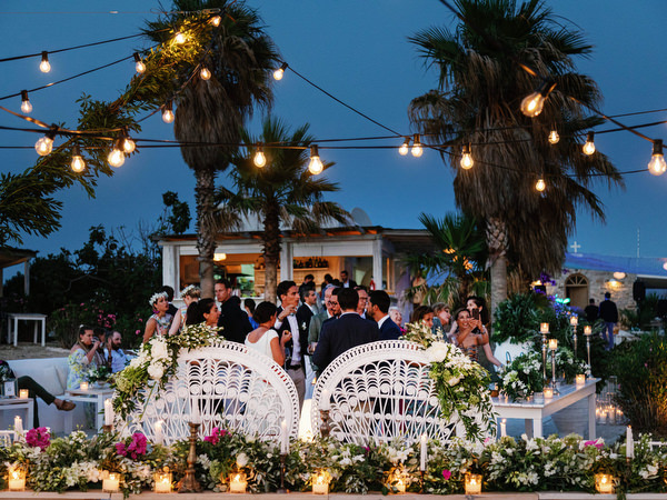 Seaside wedding reception setup in Antiparos at night.
