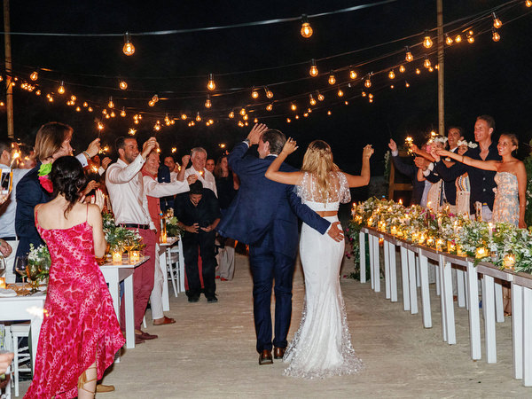 Guests cheering bride and groom at Antiparos night reception.