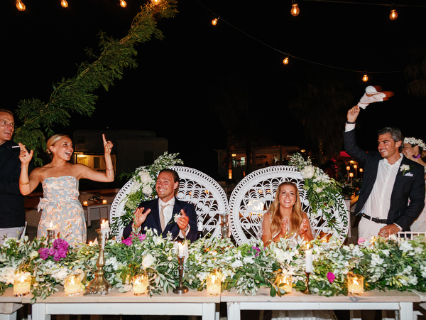 Guests celebrating at outdoor seaside wedding reception in Antiparos.