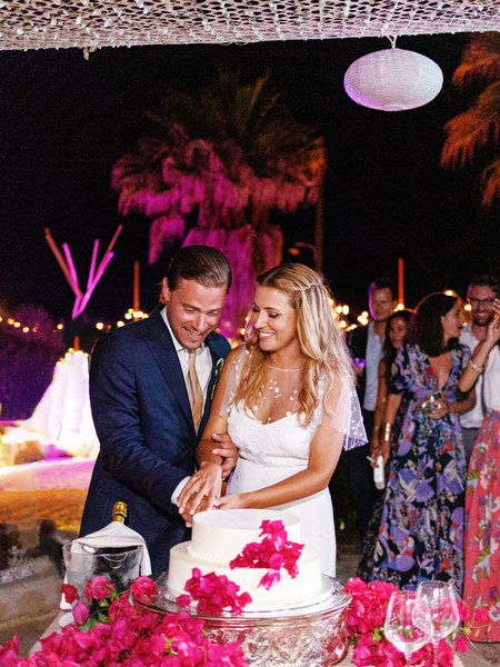 Bride and groom cutting wedding cake in Antiparos.