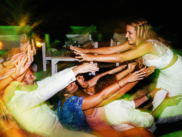 Bride dancing with guests during Antiparos night reception.