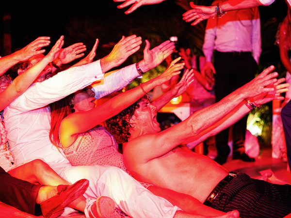 Wedding guests dancing under colorful lights in Antiparos.