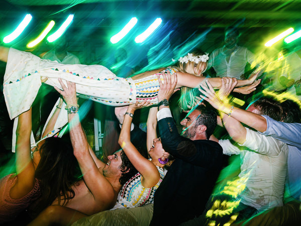 Bridesmaid crowd surfing at Antiparos destination wedding.