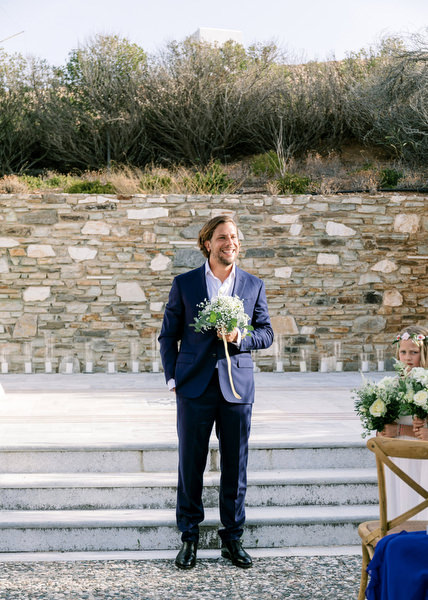 Groom waiting at outdoor Orthodox ceremony in Antiparos.