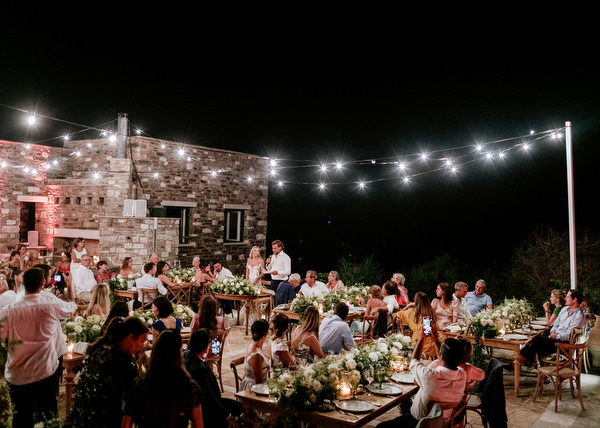 Outdoor wedding dinner under string lights in Antiparos.