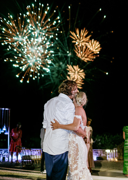 Bride and groom watching fireworks at Antiparos wedding.