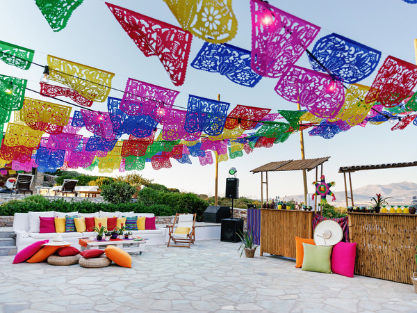 Fiesta-inspired decorations with papel picado at Antiparos pre-wedding event