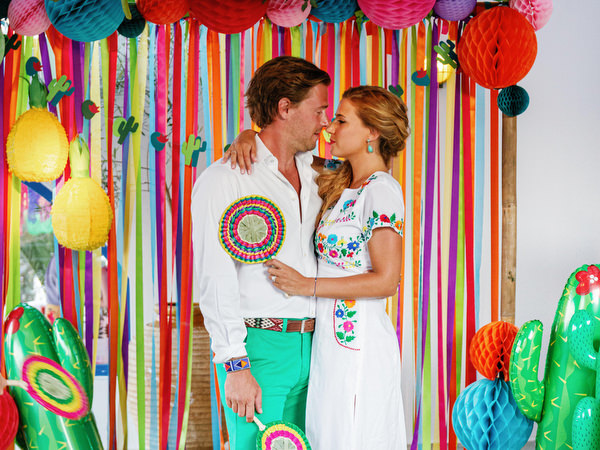 Couple portrait with colorful fiesta backdrop in Antiparos