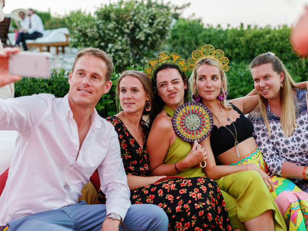 Guests taking a selfie at colorful Antiparos pre-wedding fiesta