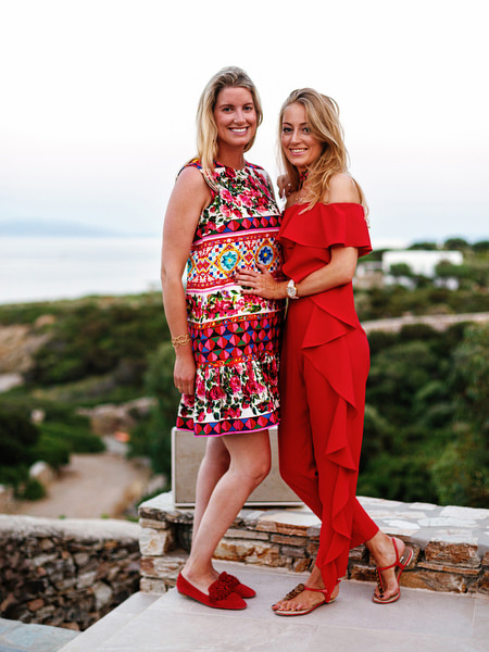 Two women in red posing during Mexican fiesta celebration