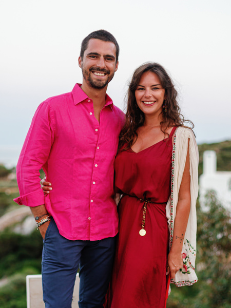 Couple portrait with bright fiesta decorations in Antiparos