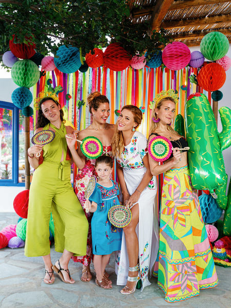 Guests gathered under festive decorations at Antiparos pre-wedding party