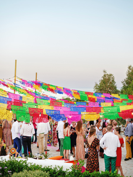 Guests gathered under festive decorations at Antiparos pre-wedding party