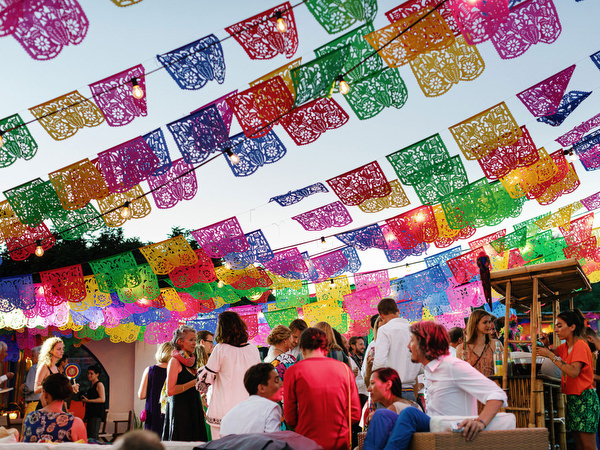 Guests dancing under colorful fiesta decorations in Antiparos