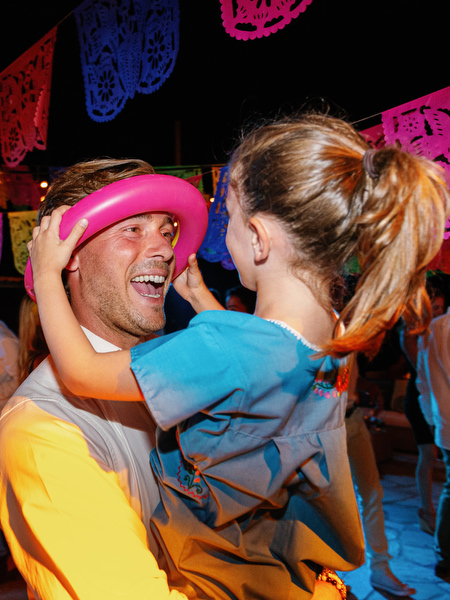 Groom and girl dancing at Mexican fiesta pre-wedding party