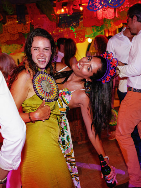 Guests celebrating on dance floor at Mexican fiesta party