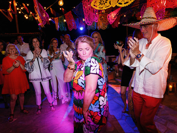 Friends dancing and celebrating during Mexican fiesta pre-wedding party
