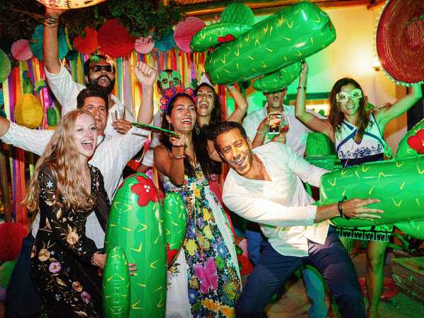 Guests celebrating with friends during Mexican fiesta pre-wedding party